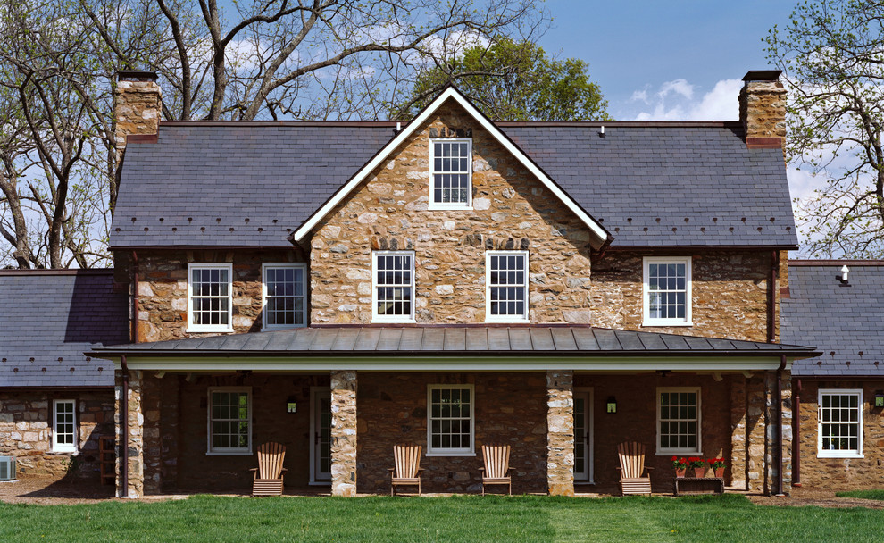 Inspiration for a mid-sized cottage beige three-story stone exterior home remodel in DC Metro with a shingle roof