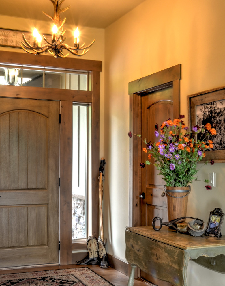 Foyer - mid-sized rustic foyer idea in Seattle with beige walls and a medium wood front door