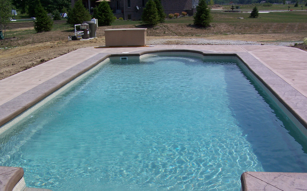 Pool - mid-sized backyard concrete and rectangular natural pool idea in Cincinnati