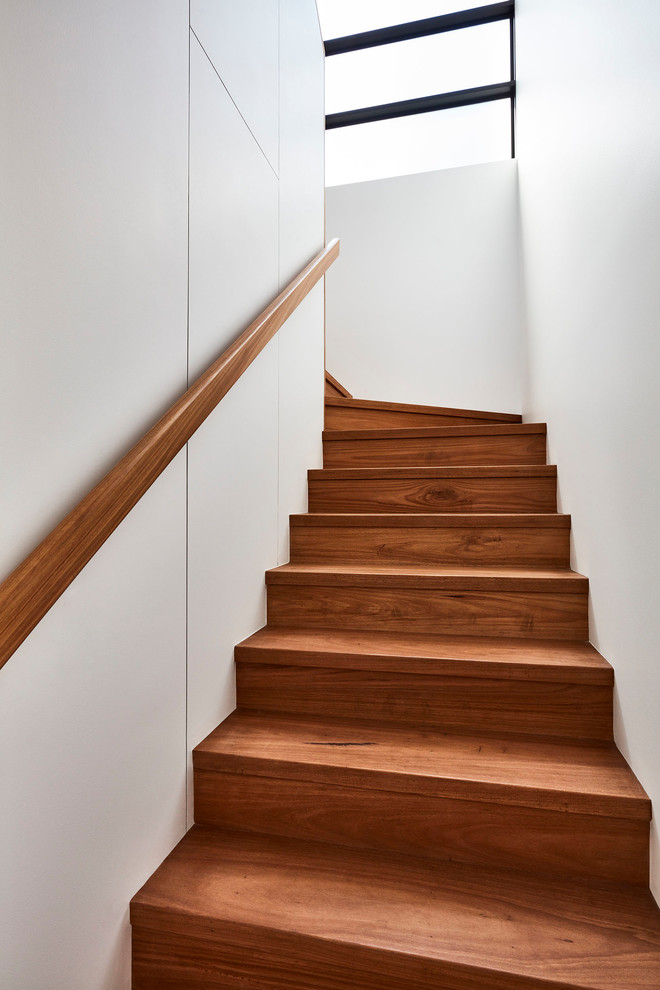 Inspiration for a contemporary wood u-shaped staircase in Sydney with wood risers and wood railing.