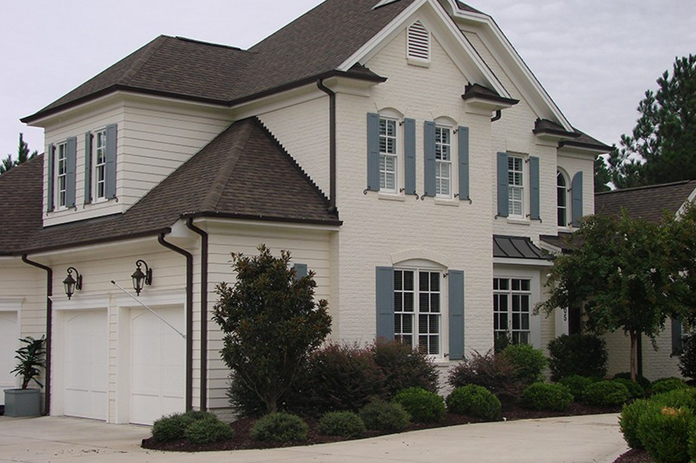 Design ideas for a large traditional two-storey beige exterior in Raleigh with mixed siding.