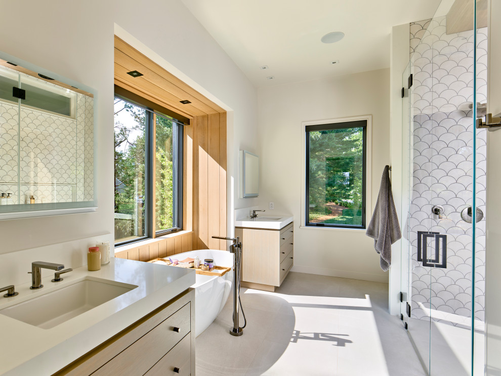 Inspiration for a mid-sized contemporary master bathroom in Philadelphia with flat-panel cabinets, light wood cabinets, a freestanding tub, white tile, an undermount sink, white floor, a hinged shower door, white benchtops, a double vanity and a built-in vanity.