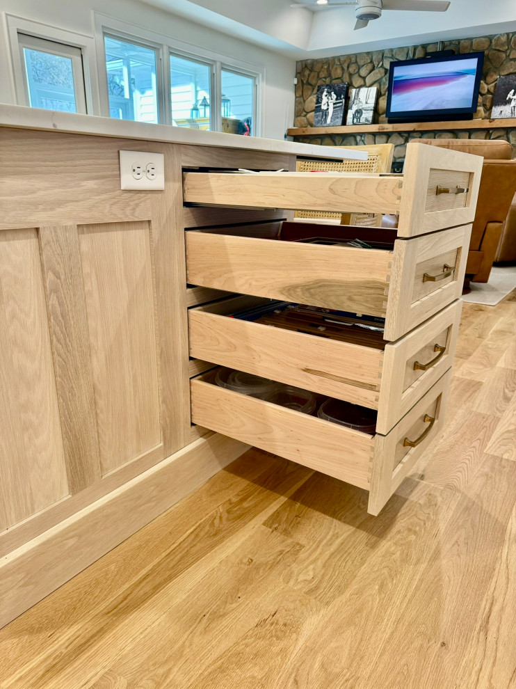 Eat-in kitchen - mid-sized transitional l-shaped light wood floor, brown floor and wallpaper ceiling eat-in kitchen idea in Atlanta with a farmhouse sink, shaker cabinets, white cabinets, granite countertops, white backsplash, stainless steel appliances, an island and white countertops