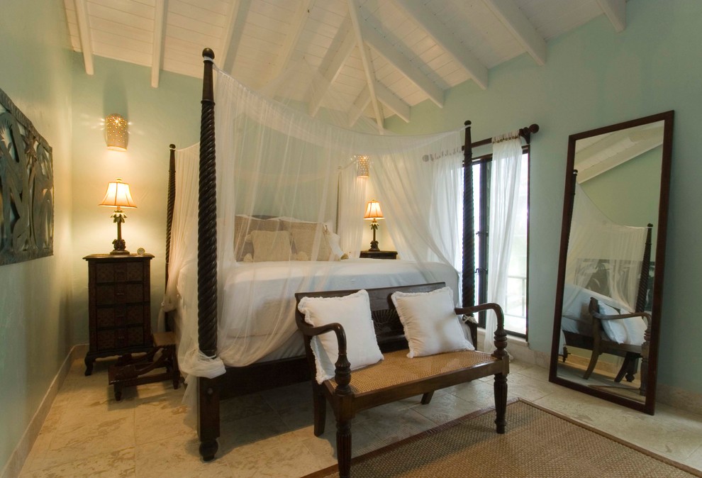 This is an example of a tropical bedroom in Tampa with blue walls.