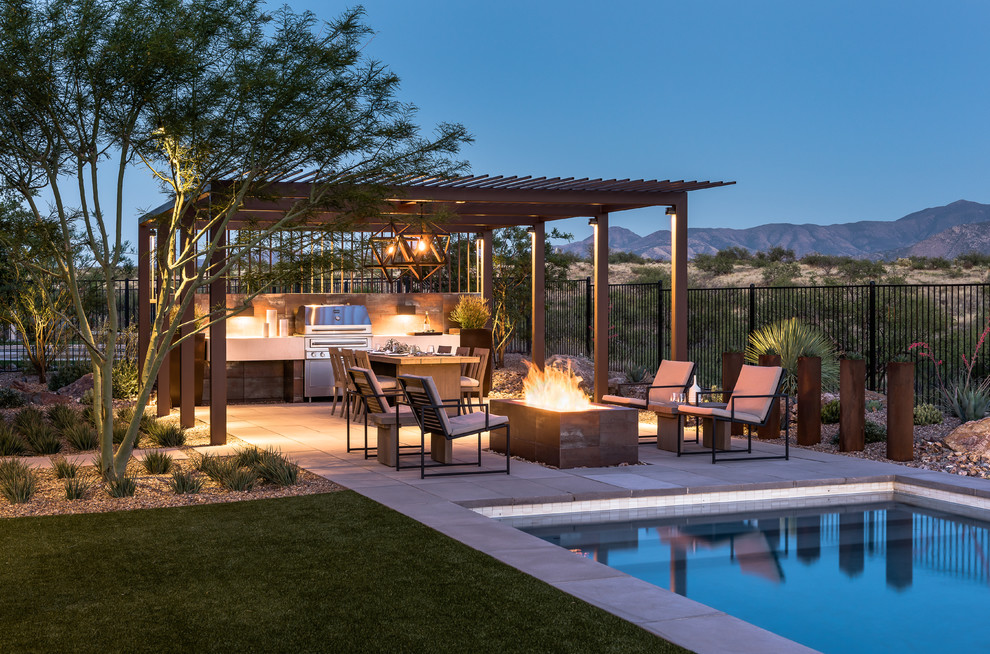 Inspiration for a mid-sized backyard rectangular pool in Phoenix with concrete pavers.
