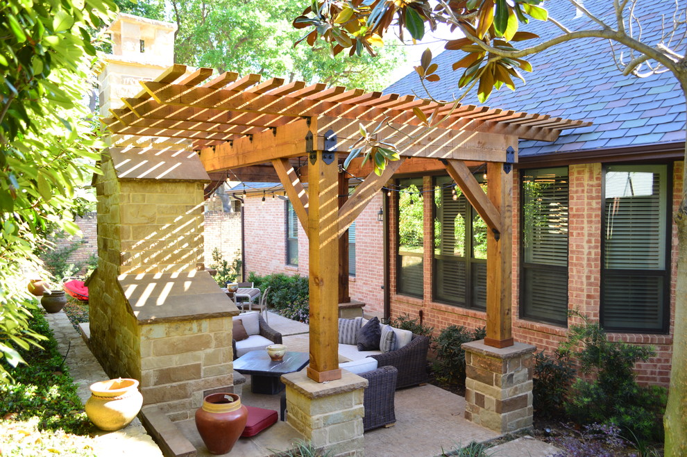 Design ideas for a mid-sized mediterranean backyard patio in Dallas with a fire feature, natural stone pavers and a pergola.