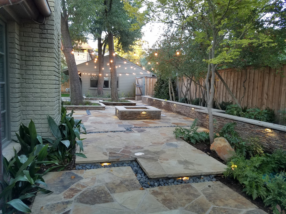 Design ideas for a mid-sized traditional backyard partial sun formal garden for summer in Dallas with a container garden and natural stone pavers.