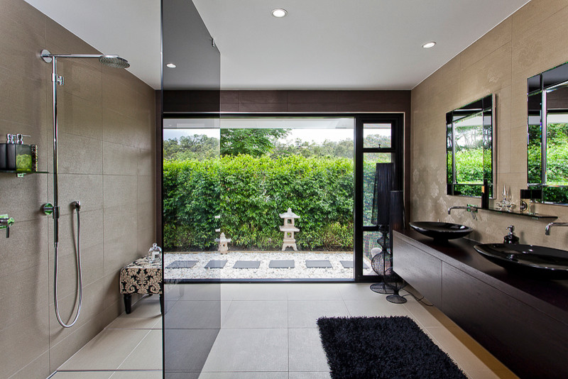 Inspiration for a large asian master bathroom in Brisbane with furniture-like cabinets, dark wood cabinets, wood benchtops, an open shower, brown tile, stone tile and mosaic tile floors.