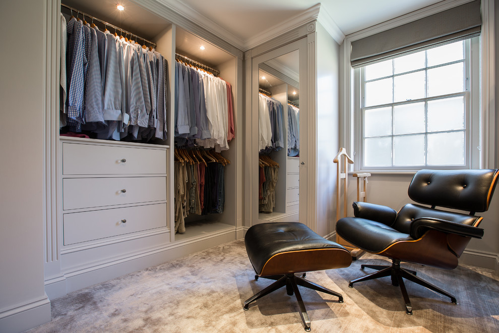Inspiration for a traditional men's storage and wardrobe in London with grey floor.