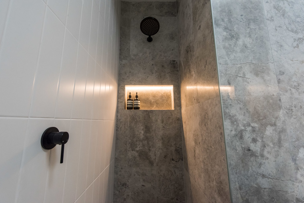 Inspiration for a mid-sized contemporary master bathroom in Melbourne with furniture-like cabinets, grey cabinets, a freestanding tub, an open shower, a one-piece toilet, white tile, marble, grey walls, marble floors, a vessel sink, marble benchtops, grey floor and a hinged shower door.