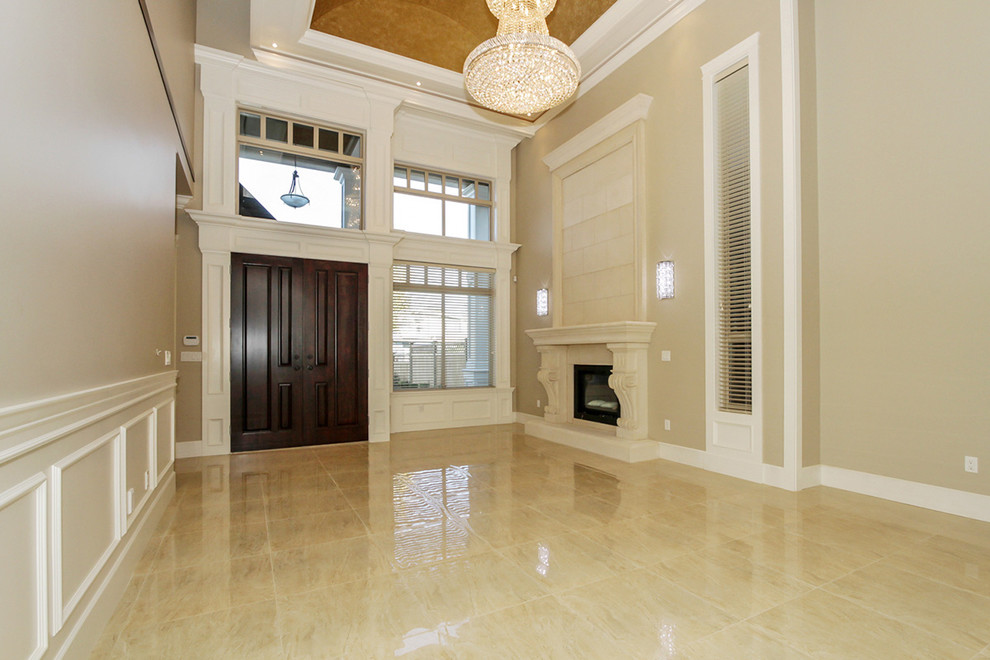 Mid-sized traditional foyer in Vancouver with beige walls, marble floors, a double front door and a dark wood front door.