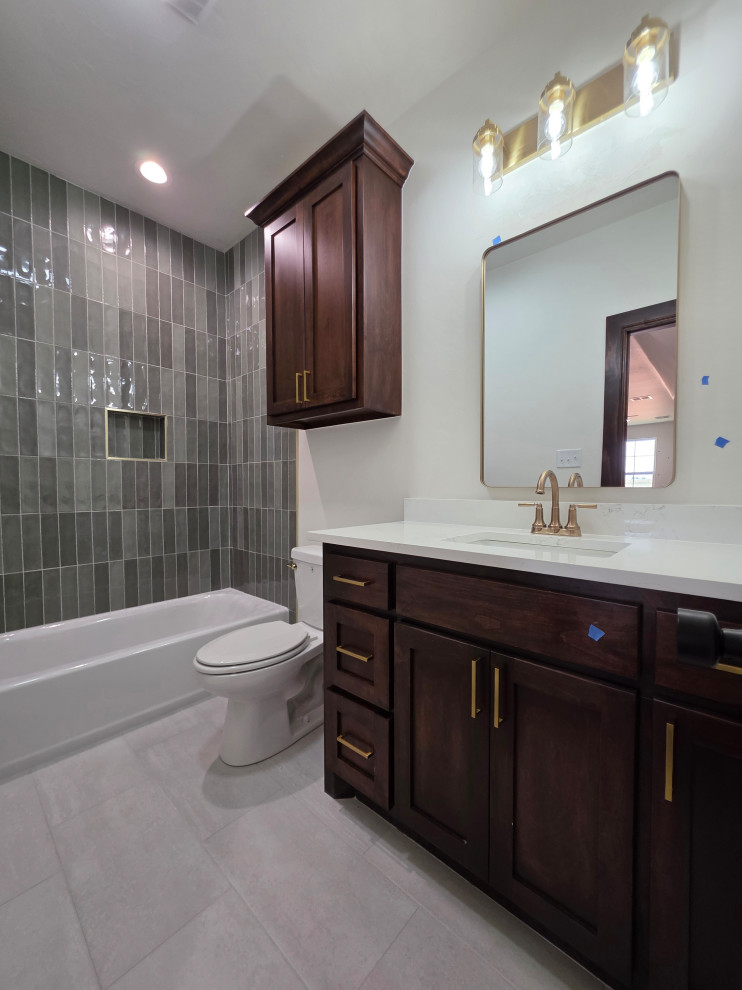 Upstairs full bath with quartz countertops, tile surround & flooring