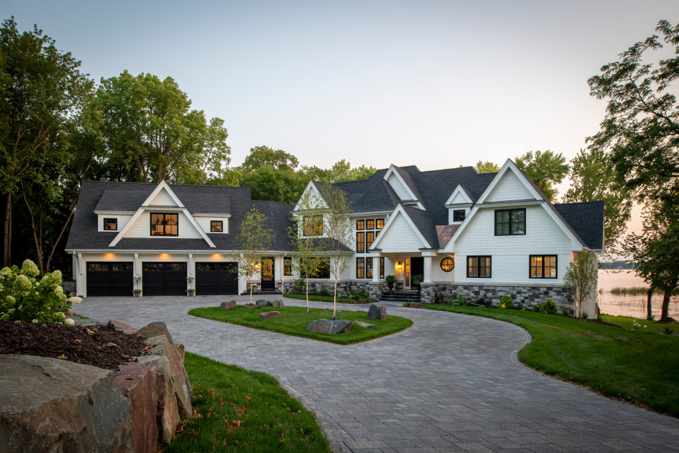 Inspiration for a large coastal white two-story mixed siding and shingle exterior home remodel in Minneapolis with a shingle roof and a black roof