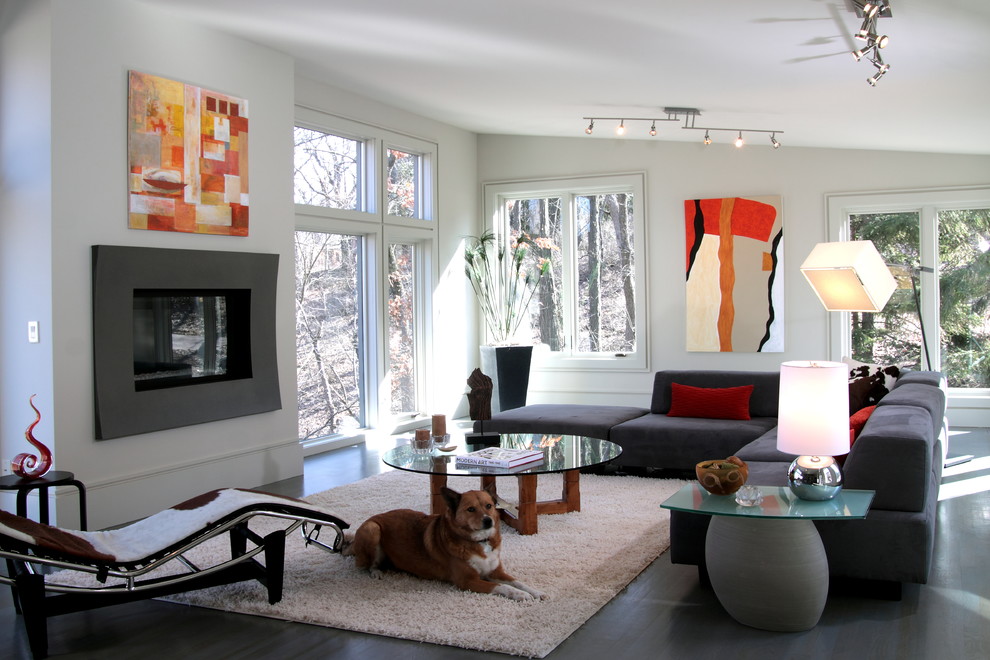 This is an example of a mid-sized contemporary formal open concept living room in Milwaukee with white walls, concrete floors, a standard fireplace, a metal fireplace surround, no tv and grey floor.