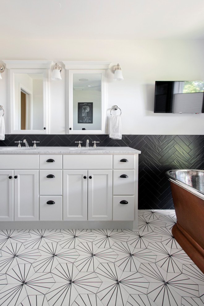 Design ideas for a small transitional master bathroom in Minneapolis with raised-panel cabinets, white cabinets, a freestanding tub, a corner shower, a one-piece toilet, black tile, stone tile, white walls, cement tiles, an undermount sink, marble benchtops, white floor, a hinged shower door, white benchtops, a niche, a double vanity and a built-in vanity.
