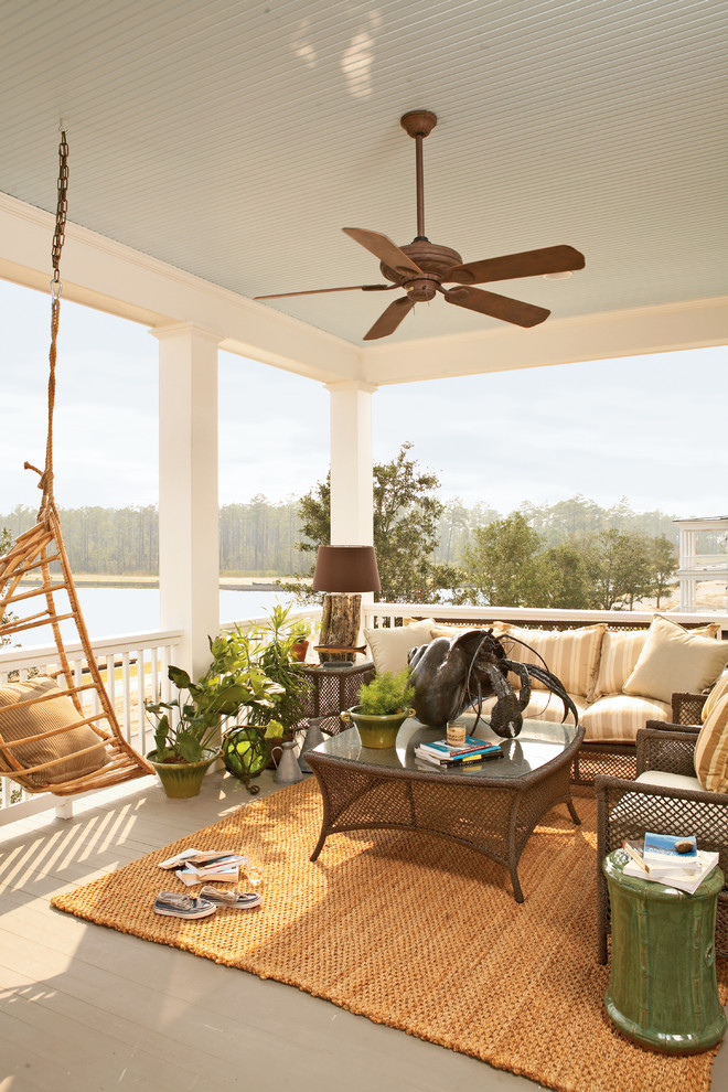 Design ideas for a mid-sized beach style balcony in Atlanta with a roof extension.