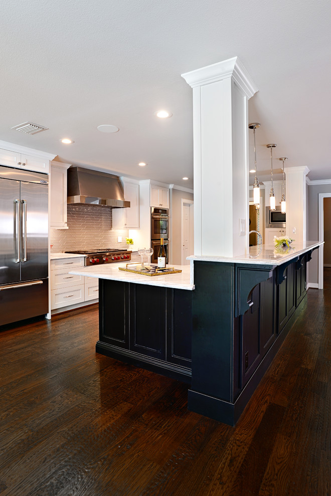 Eat-in kitchen - large transitional single-wall dark wood floor eat-in kitchen idea in Dallas with a farmhouse sink, shaker cabinets, white cabinets, marble countertops, beige backsplash, glass tile backsplash, stainless steel appliances and an island