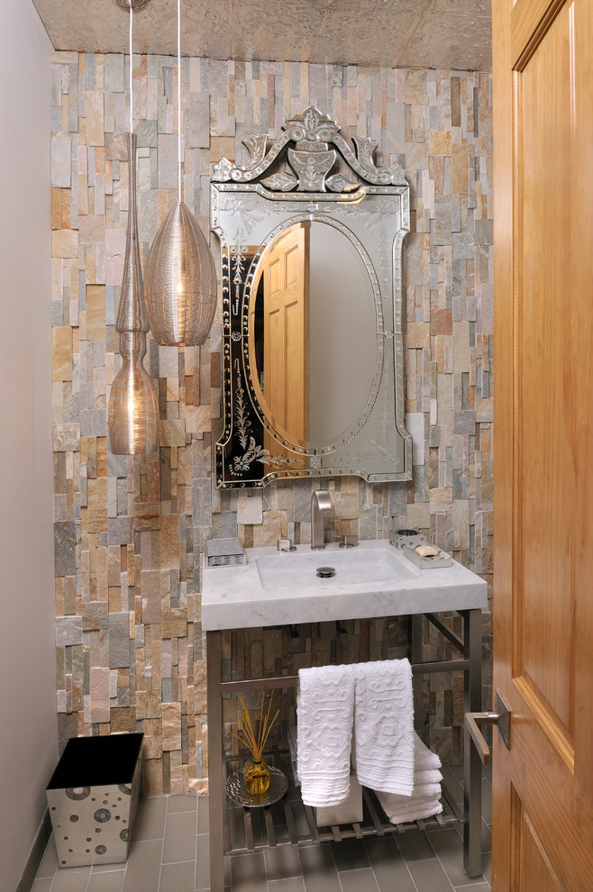 Photo of a country powder room in Charlotte with multi-coloured tile, stone tile and an integrated sink.