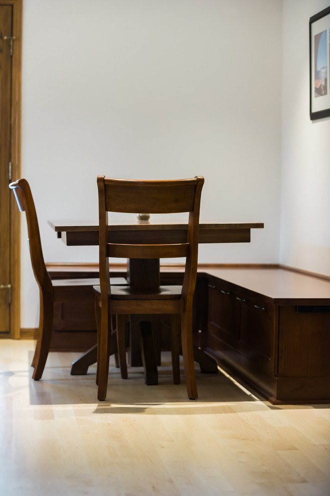 Example of a large transitional l-shaped light wood floor kitchen/dining room combo design with an undermount sink, shaker cabinets, dark wood cabinets, quartz countertops, gray backsplash, matchstick tile backsplash, stainless steel appliances and an island