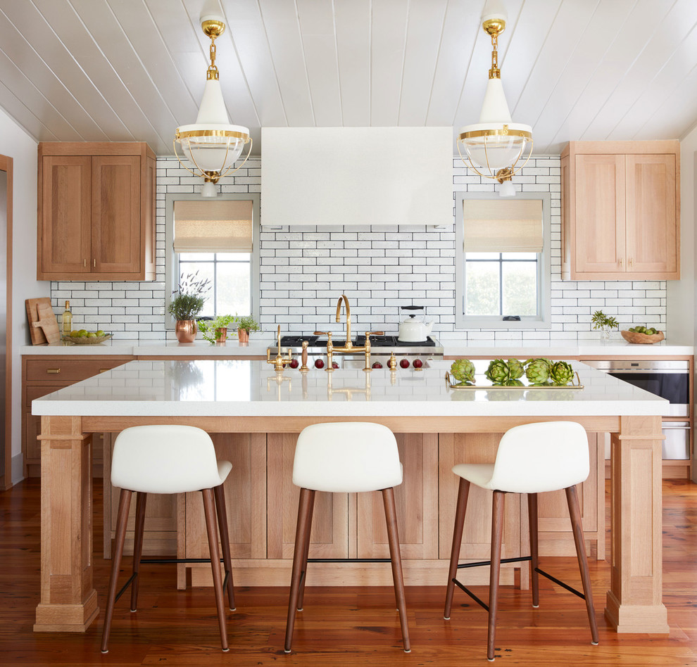 Design ideas for a mid-sized transitional galley kitchen in Jacksonville with a double-bowl sink, light wood cabinets, soapstone benchtops, white splashback, subway tile splashback, stainless steel appliances, with island, brown floor, shaker cabinets and medium hardwood floors.