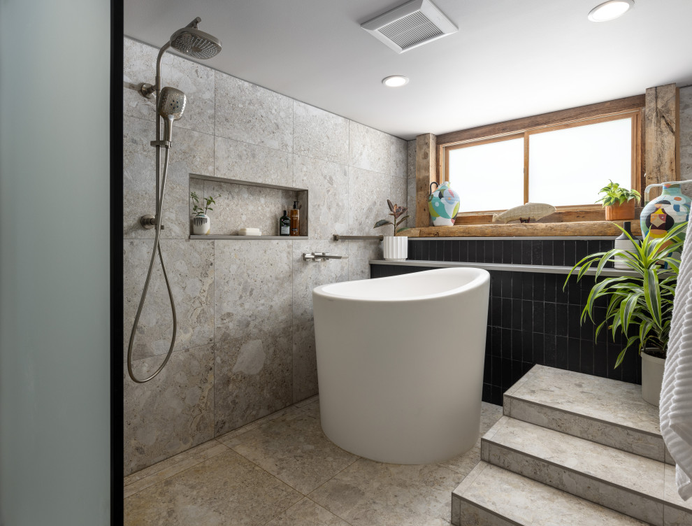 Large contemporary master wet room bathroom in Detroit with black cabinets, beige tile, grey walls, beige floor, an open shower, grey benchtops, an enclosed toilet and a single vanity.