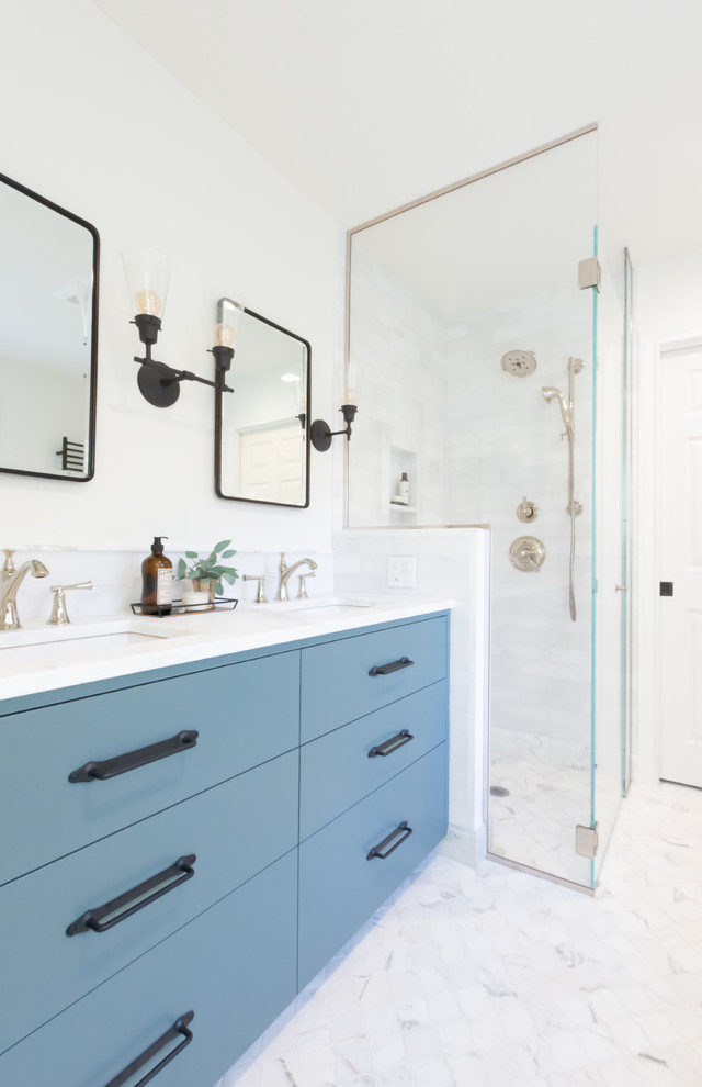 Design ideas for a mid-sized transitional master bathroom in Portland with flat-panel cabinets, blue cabinets, a freestanding tub, a curbless shower, a two-piece toilet, white tile, marble, white walls, marble floors, an undermount sink, marble benchtops, white floor, a hinged shower door and white benchtops.