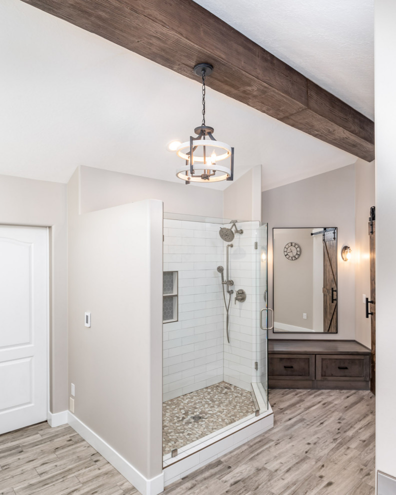 This is an example of an expansive rural ensuite bathroom in Salt Lake City with shaker cabinets, dark wood cabinets, a freestanding bath, grey tiles, porcelain tiles, a submerged sink, engineered stone worktops, white worktops, double sinks and exposed beams.