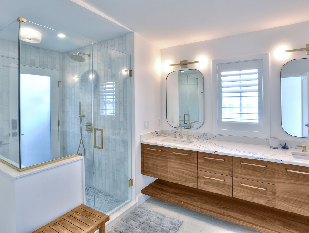 This is an example of a mid-sized scandinavian master bathroom in Bridgeport with flat-panel cabinets, medium wood cabinets, a corner shower, a one-piece toilet, blue tile, white walls, light hardwood floors, an undermount sink, engineered quartz benchtops, beige floor, a hinged shower door, blue benchtops, an enclosed toilet, a double vanity, a built-in vanity and vaulted.