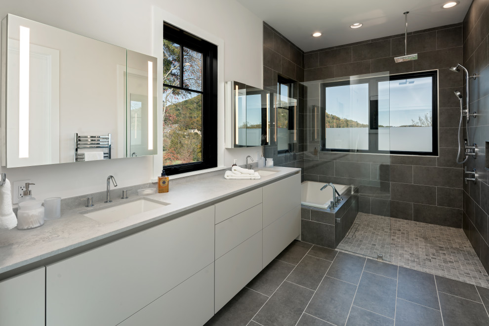 Photo of a contemporary master wet room bathroom in Other with flat-panel cabinets, white cabinets, a japanese tub, gray tile, white walls, an undermount sink, grey floor, an open shower, grey benchtops and a double vanity.