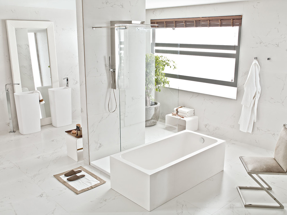Contemporary master bathroom in Perth with a freestanding tub, an open shower, ceramic tile, porcelain floors, white walls, a pedestal sink and white tile.