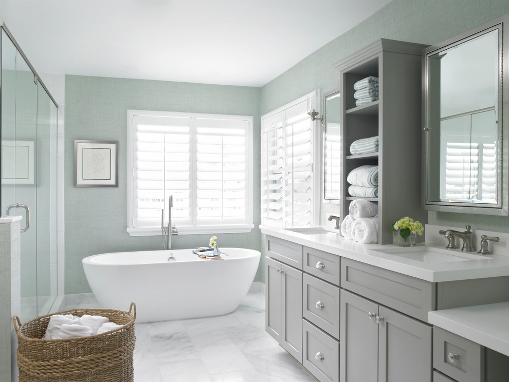 Inspiration for a beach style bathroom in Miami with an undermount sink, shaker cabinets, grey cabinets and a freestanding tub.