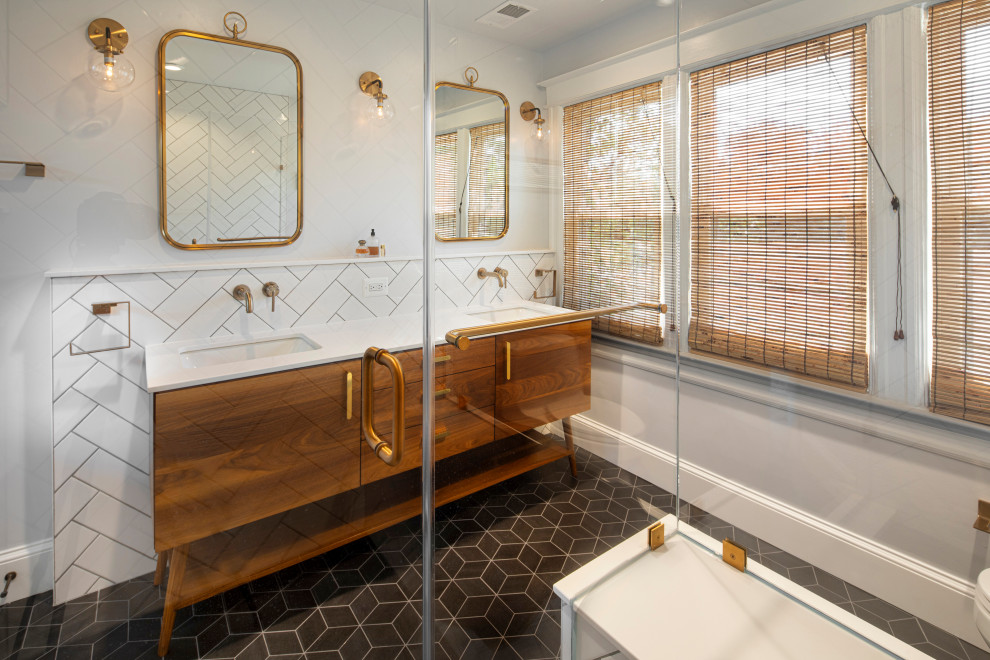 This is an example of a medium sized midcentury ensuite bathroom in DC Metro with flat-panel cabinets, medium wood cabinets, a double shower, white tiles, ceramic tiles, white walls, ceramic flooring, a submerged sink, engineered stone worktops, black floors, a hinged door, white worktops, a shower bench, double sinks and a freestanding vanity unit.