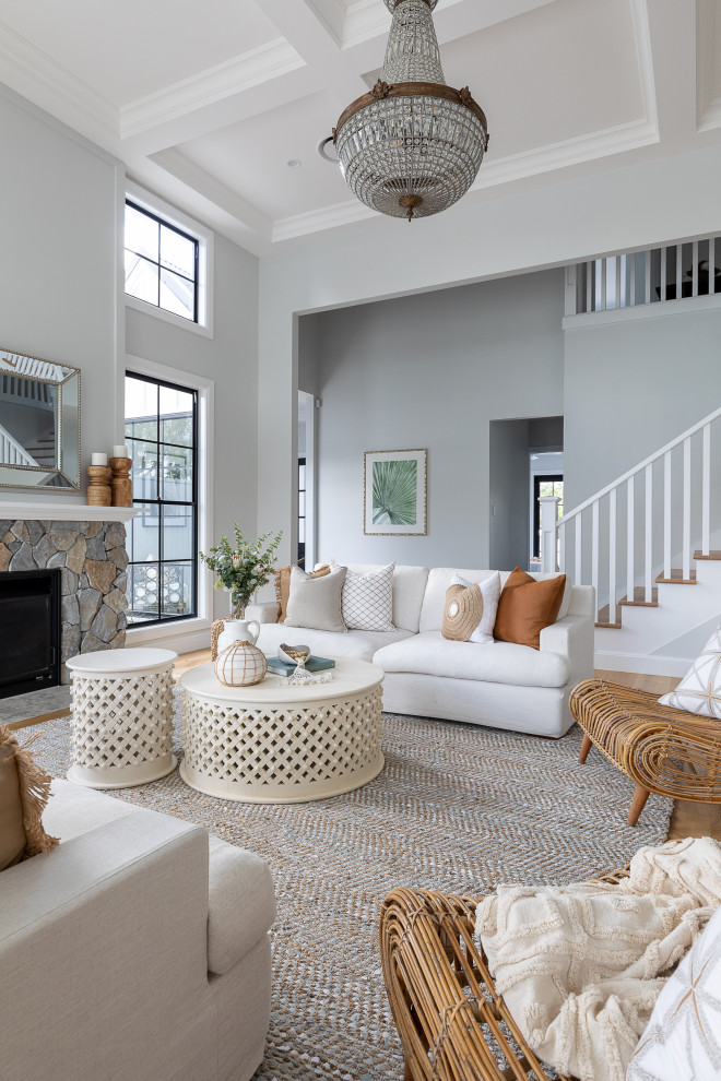 Inspiration for a transitional open concept living room in Brisbane with grey walls, medium hardwood floors, a standard fireplace, a stone fireplace surround and brown floor.