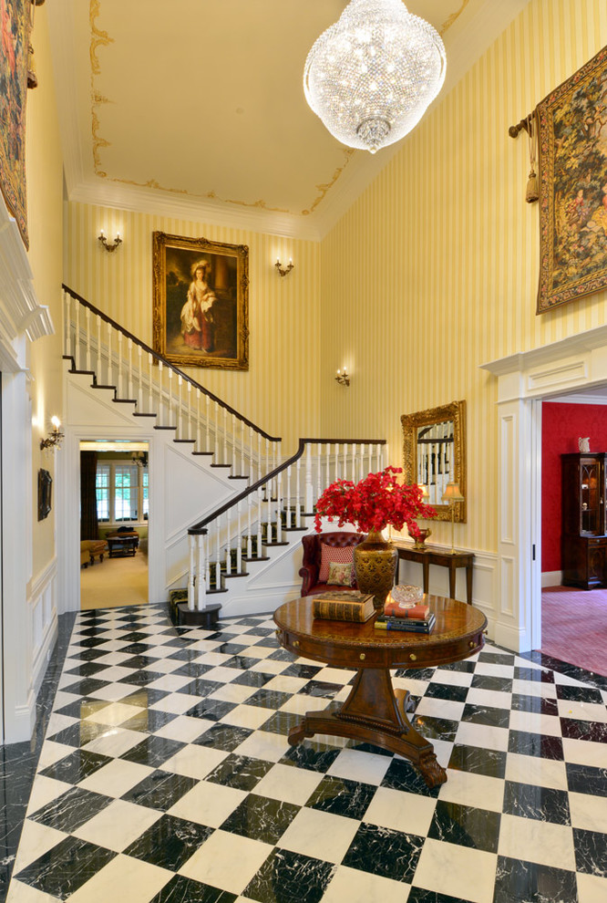 Example of a mid-sized transitional marble floor entry hall design in Seattle with yellow walls