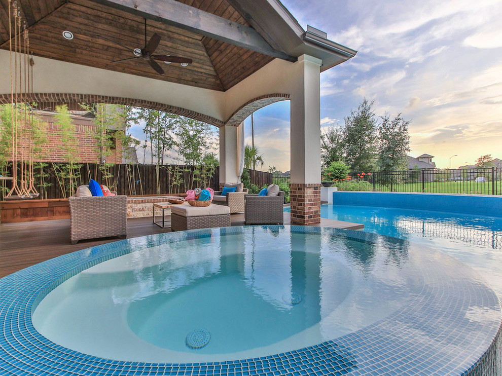 Large transitional backyard concrete and rectangular natural hot tub photo in Houston