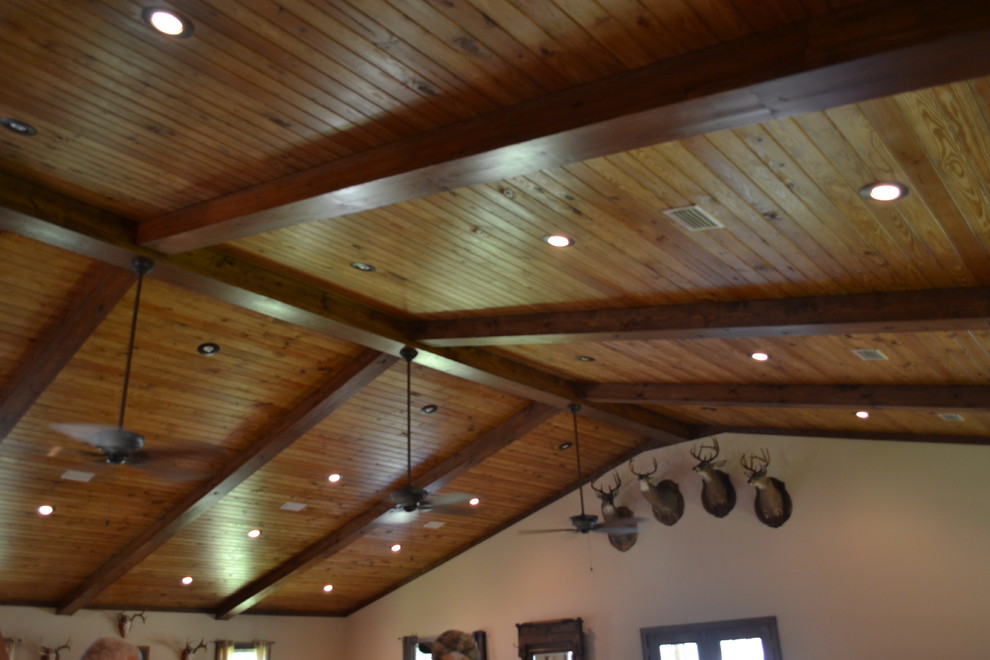 Inspiration for a mid-sized rustic u-shaped medium tone wood floor kitchen remodel in Atlanta with raised-panel cabinets, brown cabinets, granite countertops, stainless steel appliances and an island