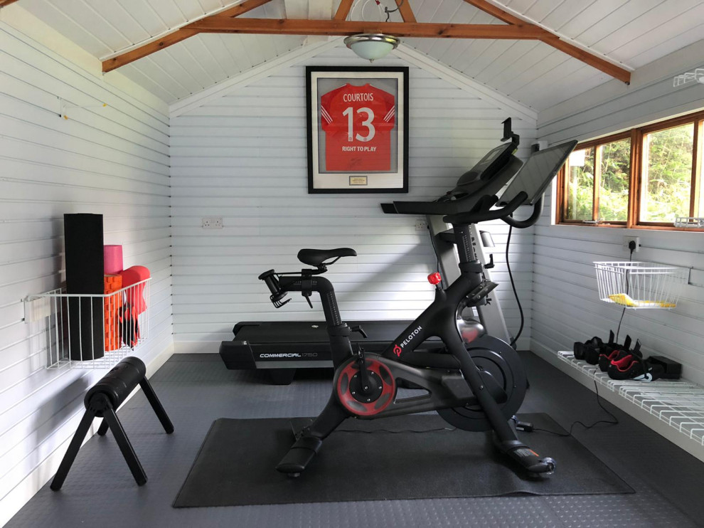 This is an example of a modern home gym in Berkshire with grey floor and vaulted.