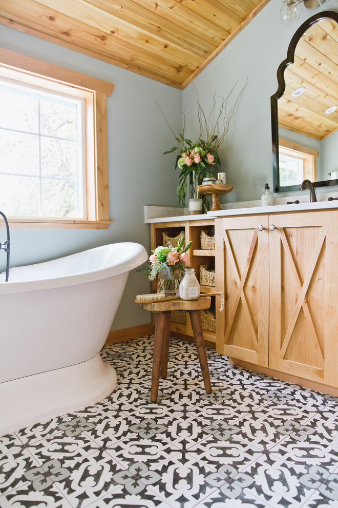 Photo of a mid-sized transitional master bathroom in Seattle with furniture-like cabinets, medium wood cabinets, a freestanding tub, an alcove shower, a one-piece toilet, white tile, porcelain tile, green walls, porcelain floors, an undermount sink, engineered quartz benchtops, multi-coloured floor, a hinged shower door and white benchtops.