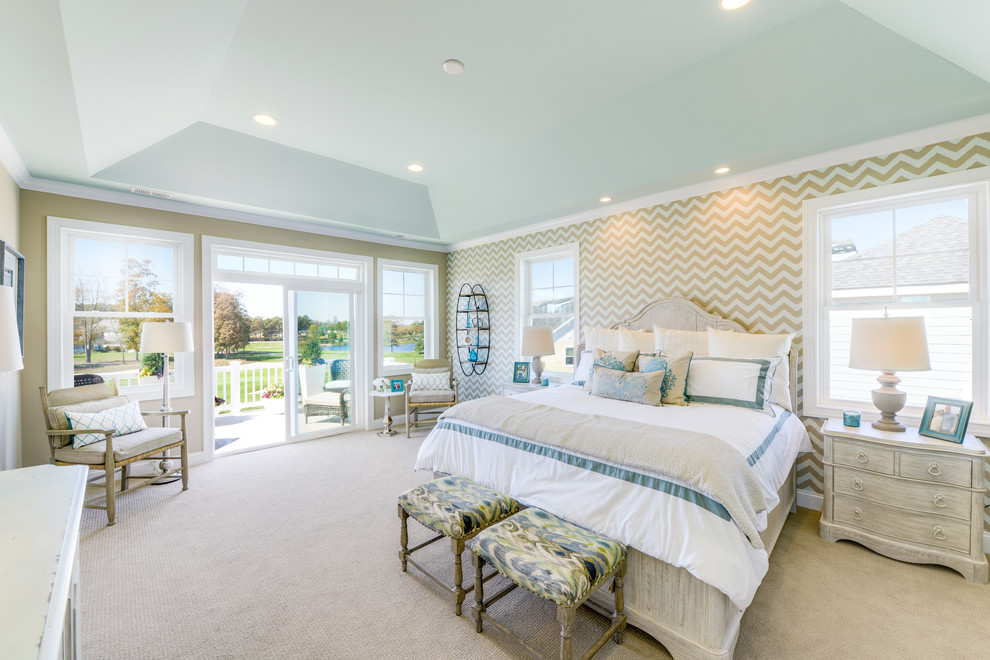 This is an example of a beach style master bedroom in Other with carpet, no fireplace and beige walls.