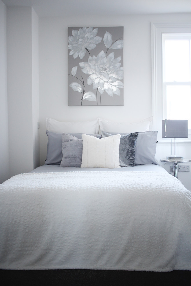 Photo of a small contemporary guest bedroom in London with grey walls and carpet.