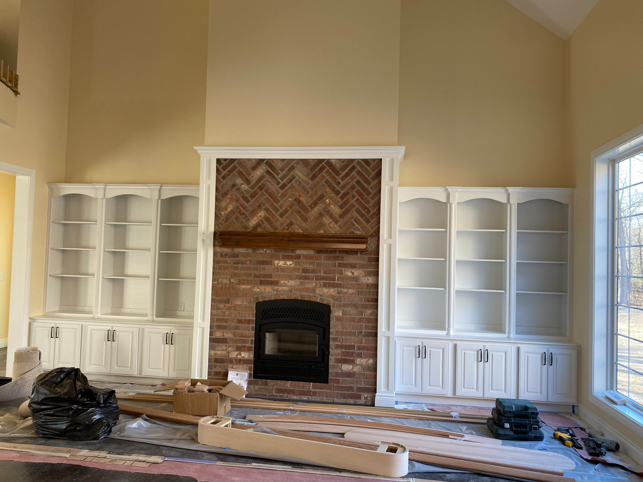 Wood burning fireplace with brick front detail and custom built ins