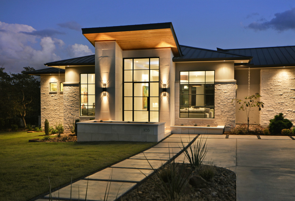 This is an example of a contemporary one-storey exterior in Austin with mixed siding.