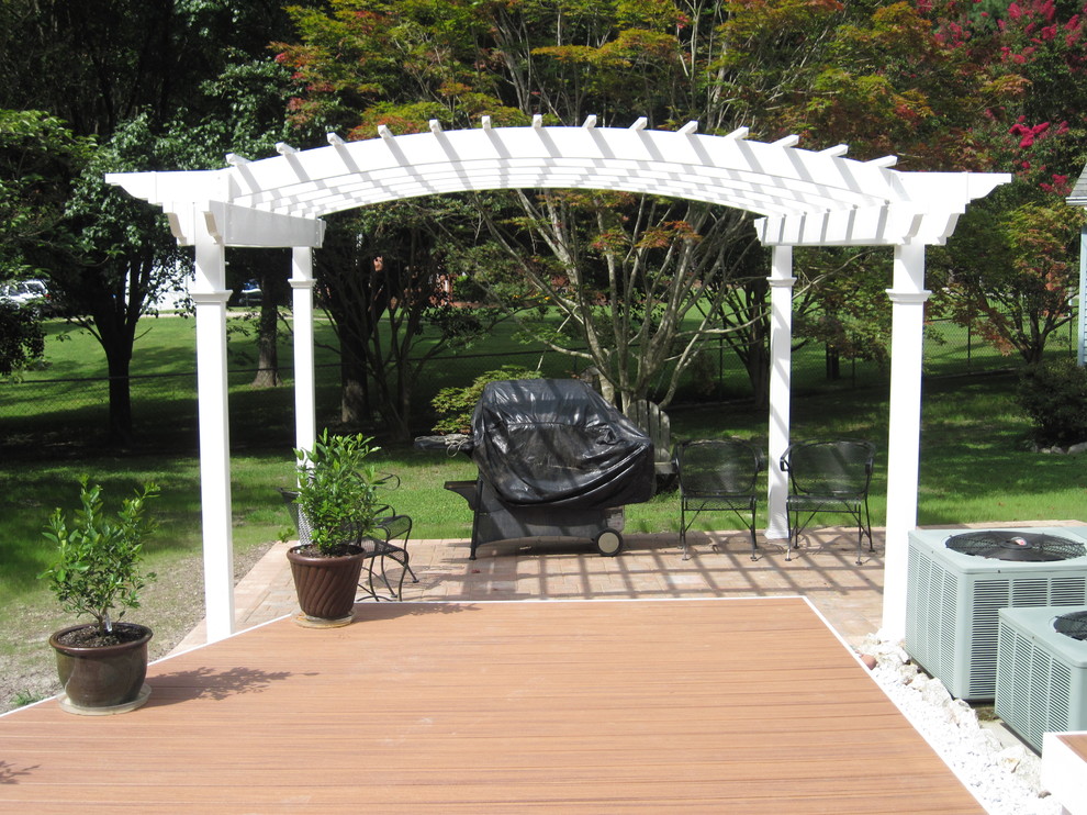 Inspiration for a mid-sized transitional backyard deck remodel with a pergola