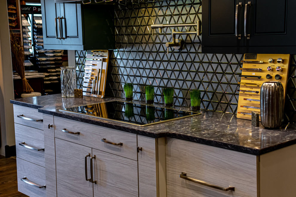 Open concept kitchen - small transitional single-wall vinyl floor and gray floor open concept kitchen idea with flat-panel cabinets, gray cabinets, quartz countertops, metallic backsplash, glass tile backsplash, black appliances, an island and gray countertops