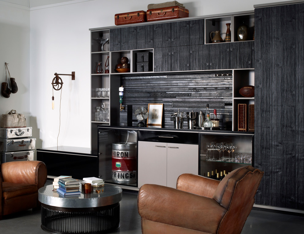 Inspiration for an industrial single-wall home bar in San Diego with flat-panel cabinets, grey cabinets, black splashback, black floor and black benchtop.