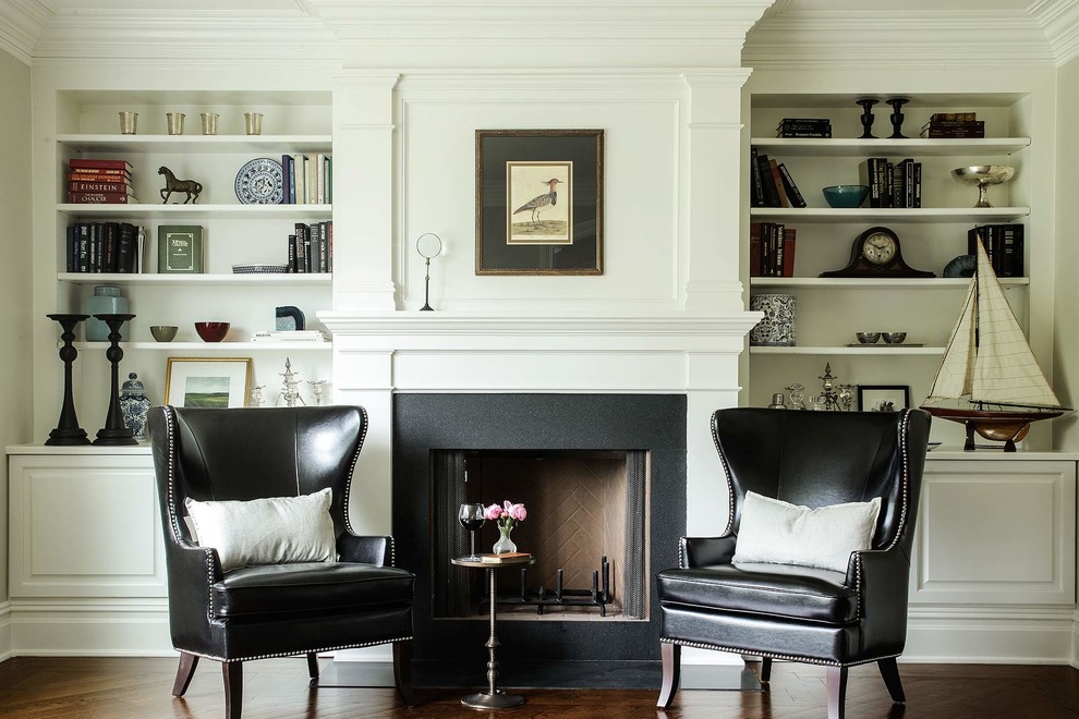 Traditional family room in New York with white walls, dark hardwood floors and a standard fireplace.