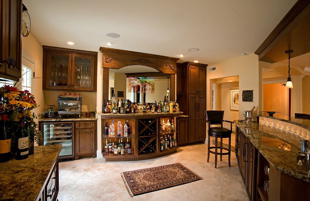 Design ideas for a large mediterranean seated home bar in Chicago with raised-panel cabinets and dark wood cabinets.
