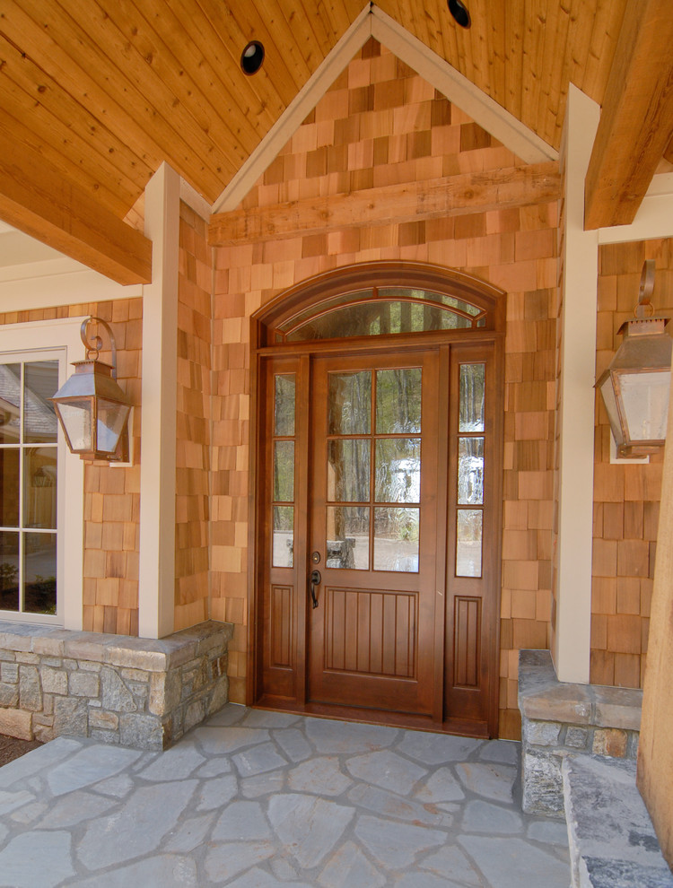 Inspiration for a large country front door in Other with a single front door and a brown front door.