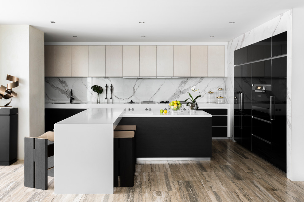 Design ideas for a contemporary l-shaped kitchen in Melbourne with an undermount sink, flat-panel cabinets, beige cabinets, white splashback, panelled appliances, with island, brown floor and white benchtop.