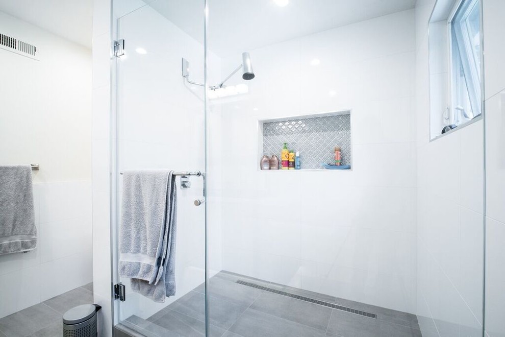Mid-sized transitional 3/4 bathroom in San Francisco with recessed-panel cabinets, light wood cabinets, an alcove shower, white tile, porcelain tile, white walls, slate floors, a drop-in sink, engineered quartz benchtops, grey floor, a hinged shower door and white benchtops.